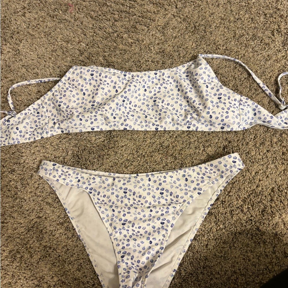 Women’s bikini. White with blue flower design. Top clips in the back